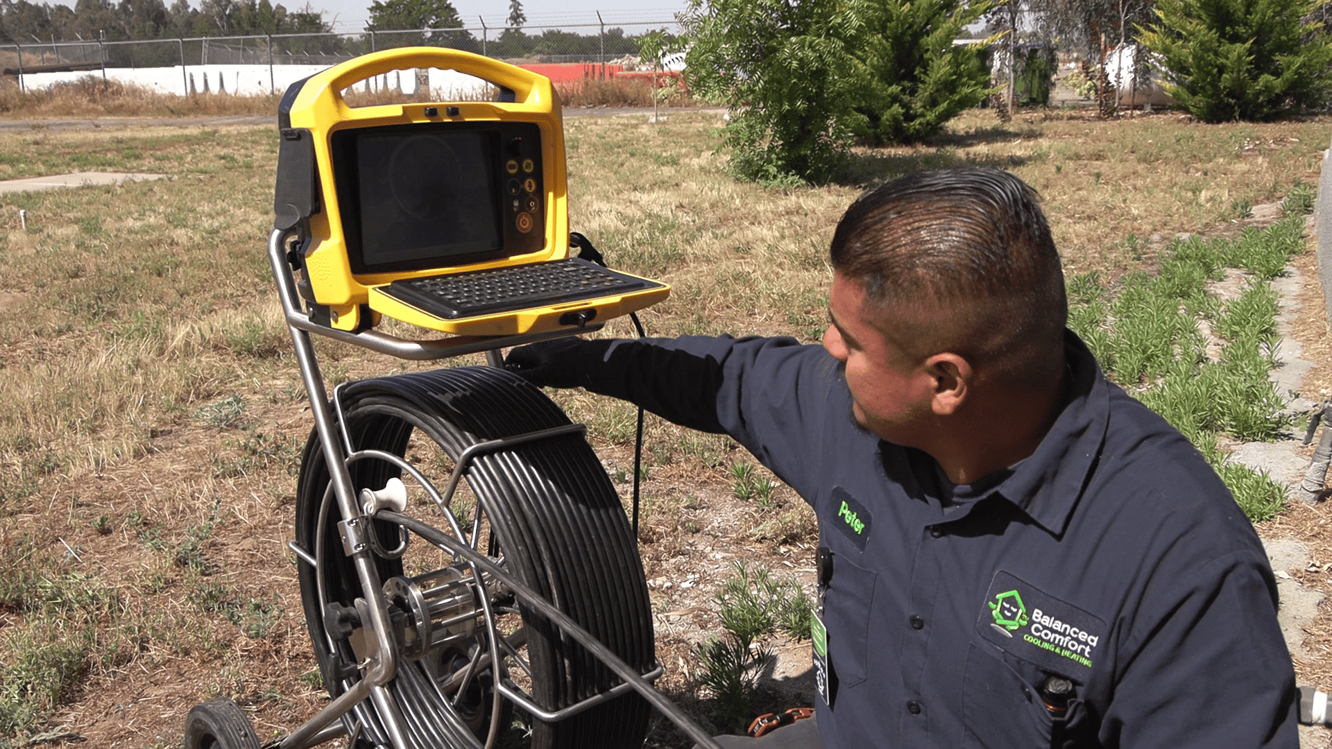 A technician performing regular maintenance on a commercial plumbing system