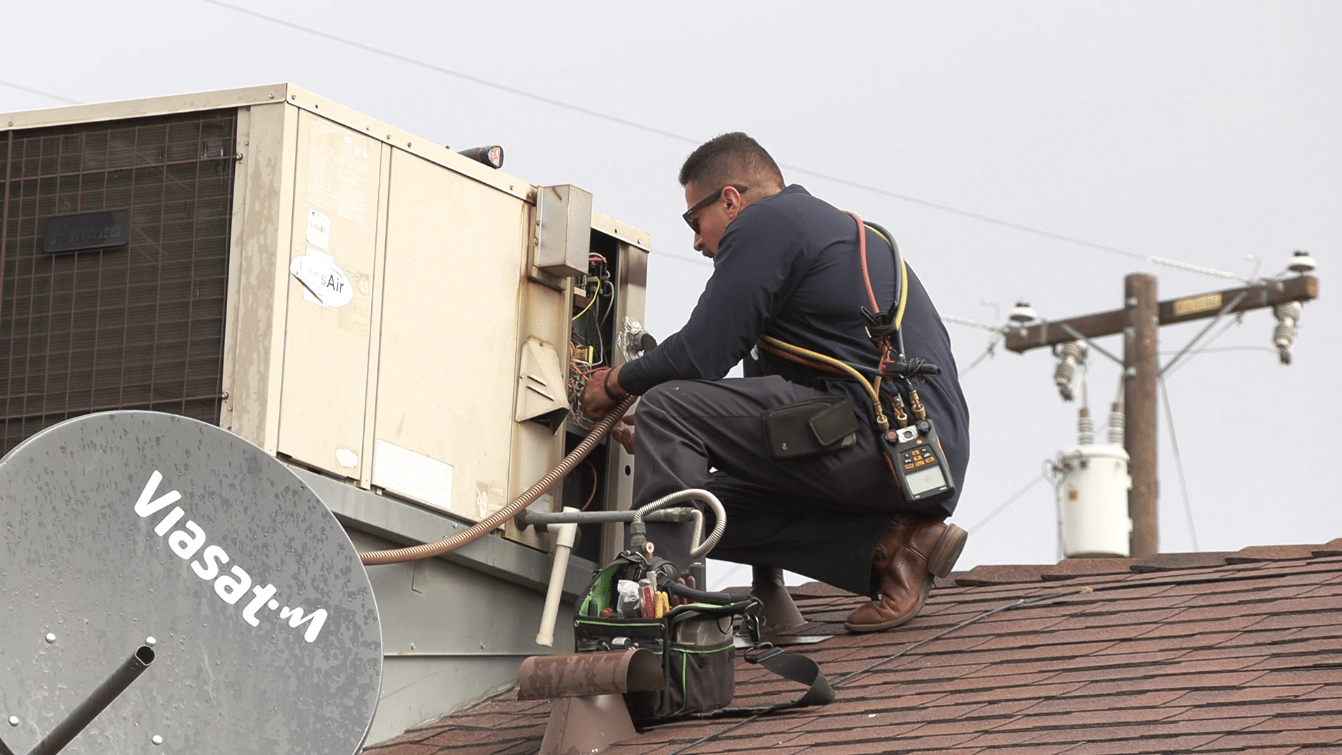 HVAC Technician working on packaged unit heat pump