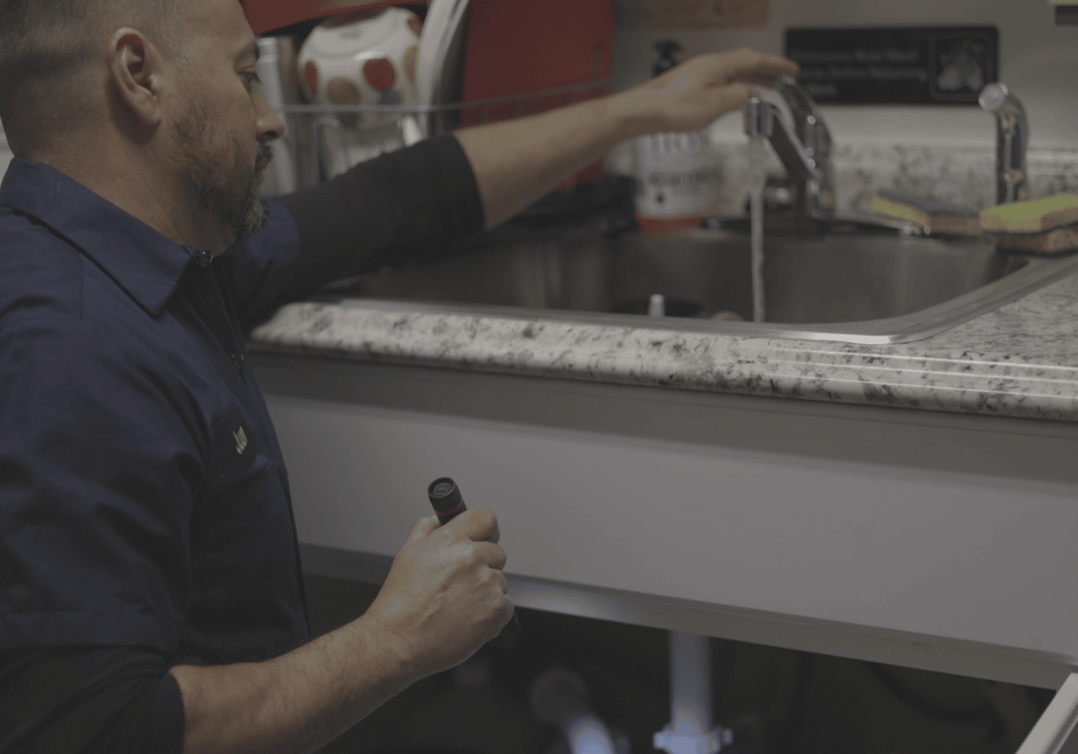certified plumber inspecting commercial plumbing